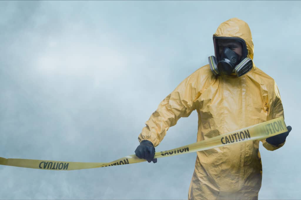 Worker in a protective suit and full-face respirator